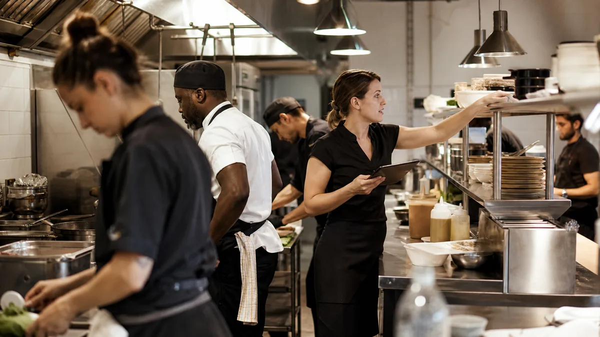 Restaurant kitchen team working through a busy service — representative image for Oregon employers